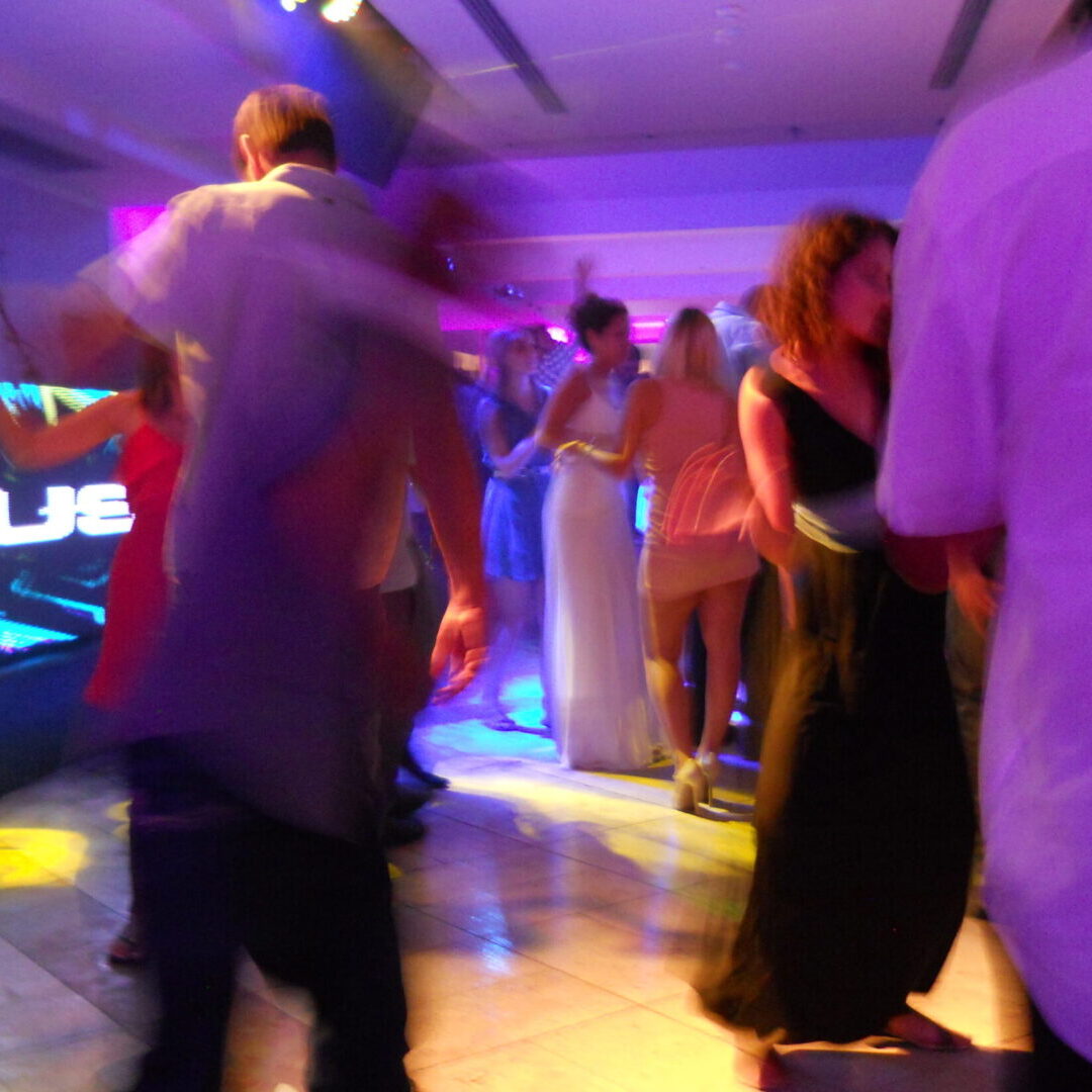 A group of people dancing in a room.