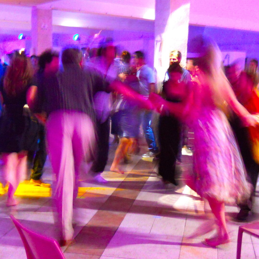 A group of people dancing in a room.