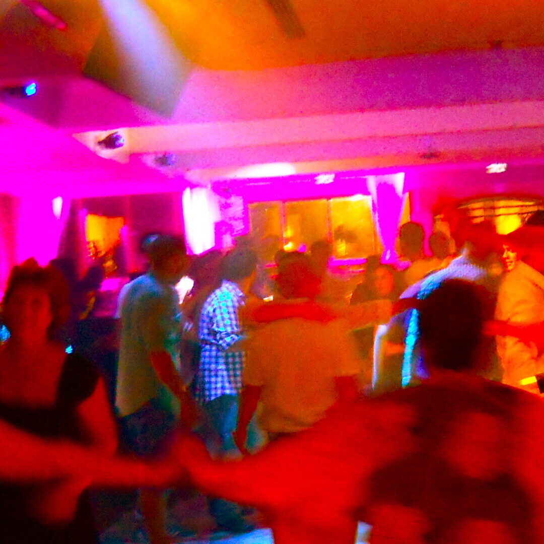 A blurry photo of people dancing in a room.